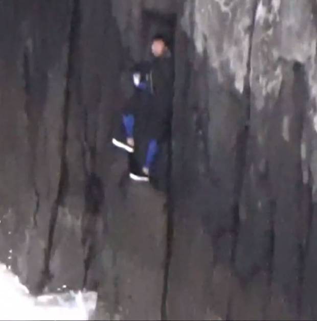 The men were sheltering from an incoming tide and large swells. Photo / Westpac Rescue Helicopter