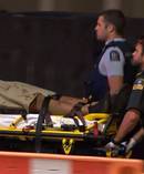 An injured person is taken from the scene of the street fight in Panmure on Friday night. Photo / Sam Sword