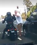 The motorcyclist and the car driver battle it out at traffic lights. Photo / Facebook
