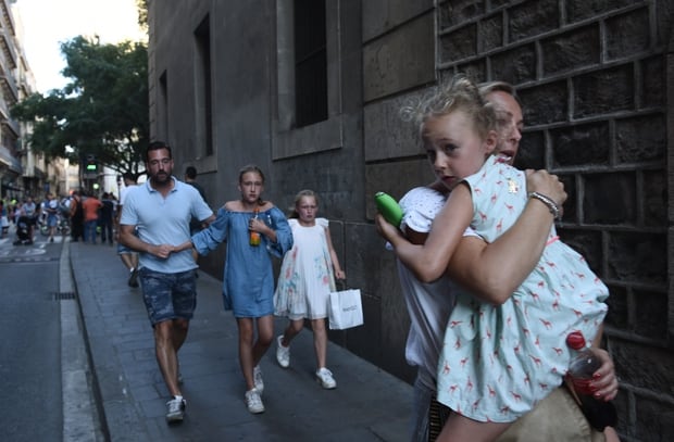 People flee the scene in Barcelona in Barcelona. Photo / AP