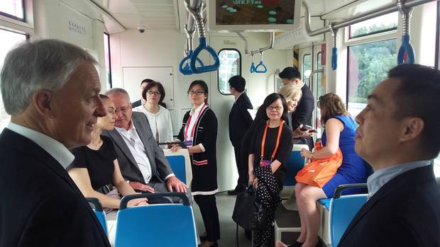 Auckland mayor Phil Goff, with councillor Ross Clow in the background, riding the Guangzhou tram in October. Photo/Chris Darby