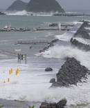 Huge waves crash over the breakwater at Port Taranaki, dislodging rocks from the seawall and flooding the carpark, during the 3.7m king high tide in New Plymouth. Photo / Mark Mitchell
