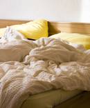 You should avoid making your bed in the morning as it seals in the bacteria and germs. Photo / Getty Images