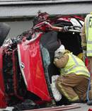 Firefighters work to free two people trapped in a vehicle involved in a two-vehicle crash at Maheno, 14km southwest of Oamaru, last weekend. Photo / Daniel Birchfield 