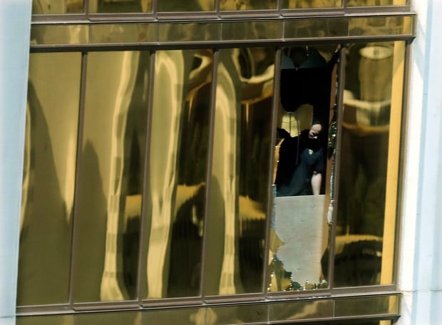 An investigator works in the room at the Mandalay Bay Resort and Casino where Stephen Paddock opened fire on a music festival, in Las Vegas. Photo / AP