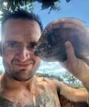 Russell Hogg with the flounder that fell from the sky and onto his head. Photo / supplied