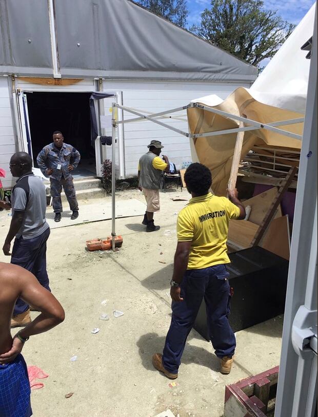 Papua New Guinea immigration officials remove sun shelters from the Manus Island detention center. Photo / AP