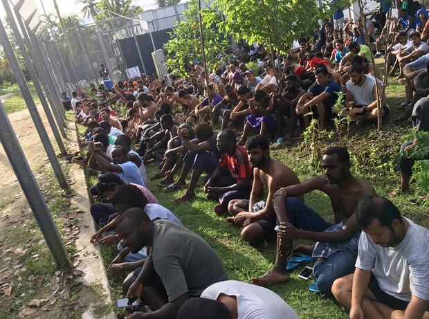 Asylum seekers sit on the ground as they refuse to leave the Manus Island detention center in Papua New Guinea Photo / AP