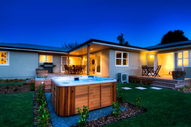 Relax in The Farmhouse's hot tub and look to the skies. Photo / Supplied