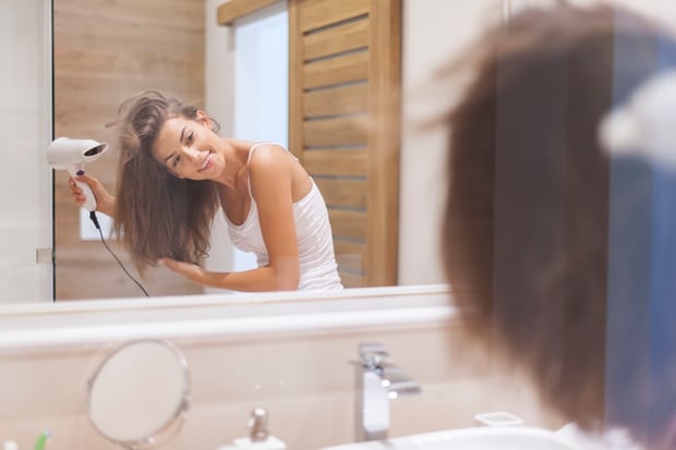 While drying your hair upside down does give it volume, the best thing is to get the nozzle of the dryer as close to the scalp as possible to get lift. Photo / Getty Images