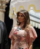 First lady Melania Trump looks on as President Donald Trump speaks with reporters after arriving for a New Year's Eve gala at his Mar-a-Lago resort. Photo / AP
