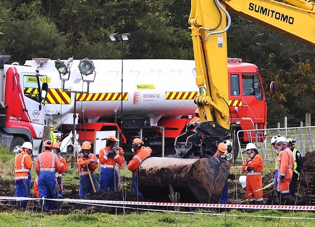 New Zealand Refinery staff at the site of a jet fuel pipeline leak on farm land between State Highway 1 and Marsden Pt Rd. Photo / John Stone