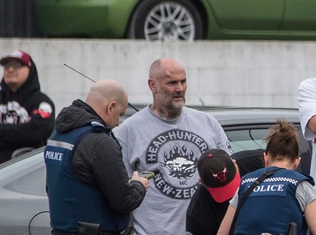 Police talk to Senior Head Hunters gang member Wayne Doyle. Photo / NZ Herald