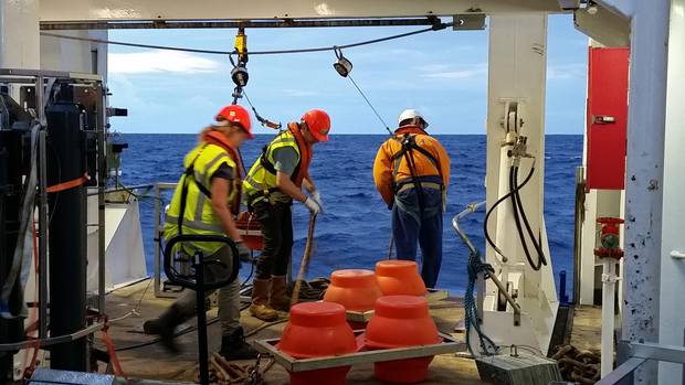 Crew onboard Niwa research vessel Tangaroa lower the corer into the Kermadec Trench. Photo / Niwa