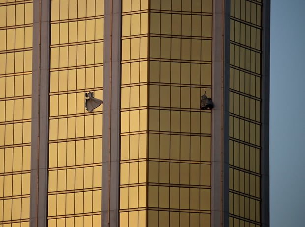 Drapes billow out of broken windows of the room at the Mandalay Bay resort and casino where Stephen Paddock shot at concertgoers. Photo / AP