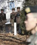 In this Nov 27, 2017 photo: North Korean soldiers look at the South side as a South Korean stands guard near the spot where a North Korean soldier crossed the border on Nov 13. Photo / AP