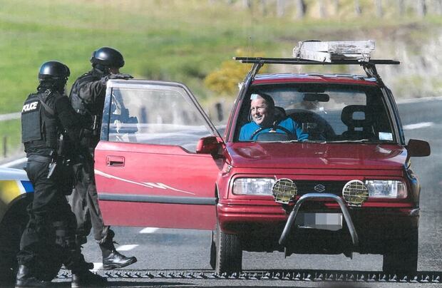 The only survivor of the Northland triple shooting, Jeff Pipe, talks to Armed Offenders members after being shot. Photo / John Stone