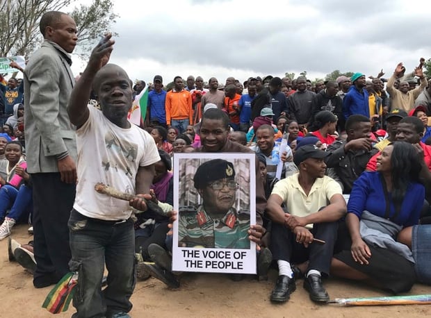 People gather to demonstrate, with an image of General Constantino Chiwenga. Photo / AP