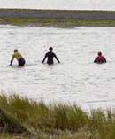 Police waders are scouring the river mouth of the Tukituki River, which lets out near the beach. Photo / Warren Buckland