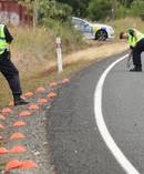Police serious crash investigators mark out the car's path at the fatal crash, State Highway 12, Omanaia where a child was killed.