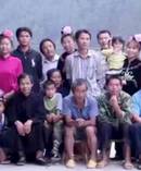 Huang Yuzhong, first row, fourth from left, with his family including his mother, far right and father second from right, sitting. Photo / Lijia Zhang