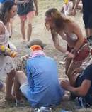Madeline Anello-Kitzmiller hits the man as her friend pours a drink on him