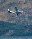 An NZONE plane over Lake Wakatipu during rescue operations to find two missing skydivers. Photo/James Allan
