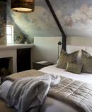 The couple have faithfully honoured James Chapman-Taylor's design, such as in the bedroom.