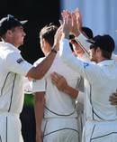 Tim Southee and Black Caps teammates celebrate a wicket. Photosport