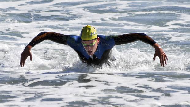 David Boles hits the sand first at the end of the Sand to Surf race at Mount Main Beach on Saturday. Photo / Andrew Warner