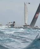 Wild Oats XI (NSW) skippered by Mark Richards is followed by leisure craft through the Heads. Photo / Photosport