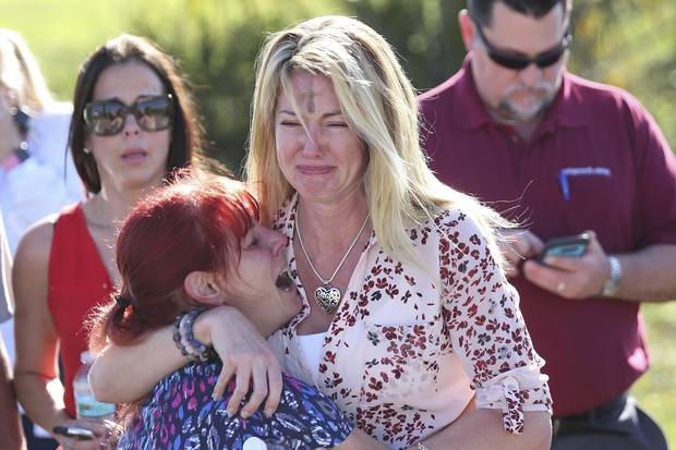Parents wait for news after the shooting at Marjory Stoneman Douglas High School in Florida. Photo / AP 