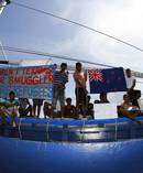 Sri Lankan asylum seekers hold signs and plead for assistance as they seek asylum to New Zealand in 2011. Photo / Getty Images