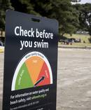 A sign at Takapuna Beach warning people of the water quality on the beach. Photo / Nick Reed