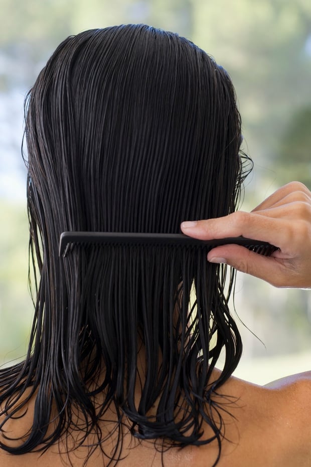 You should comb your wet hair slowly to minimise damage, rather than using a brush. Photo / Getty Images