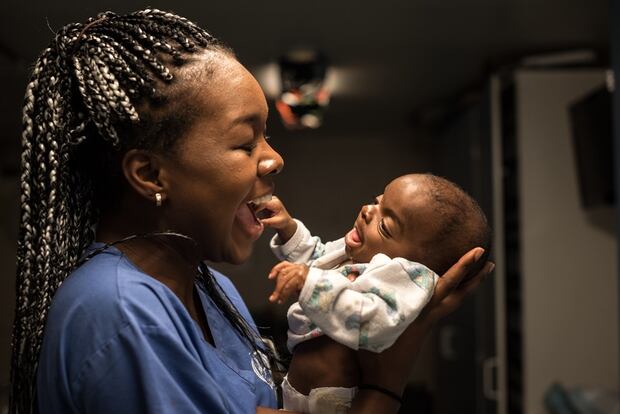 Former Whanganui High School student, Deborah Adesanya, holds baby Djaliou on the ward. Photo/supplied.