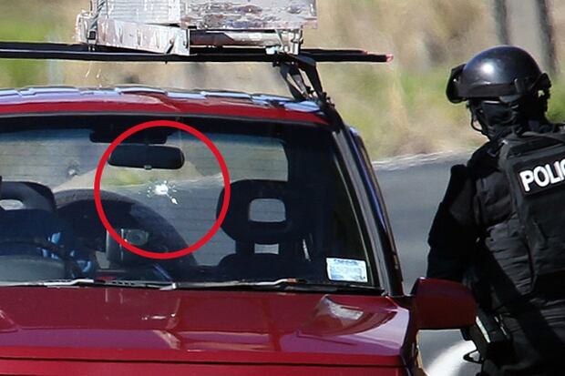 Emergency services at the scene of a shooting on Mt Tiger Rd, near Whangarei. A bullet hole can be seen in the windscreen of a car. Photo / Northern Advocate 