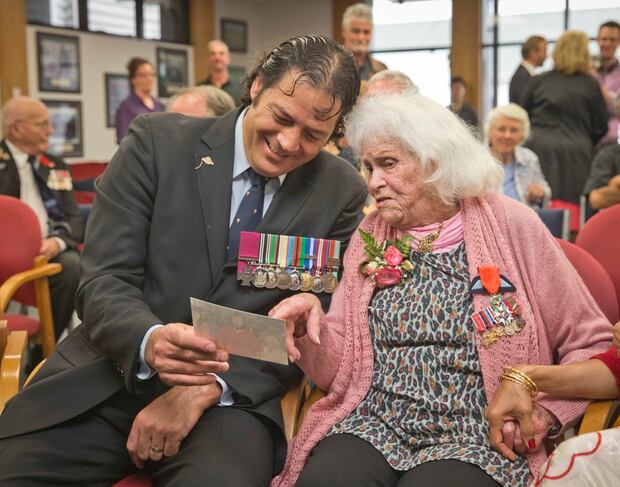 Victoria Cross winner and former SAS soldier Willie Apiata spends a moment with Pippa Doyle after she received the Legion of Honour medal in 2014. Photo/File