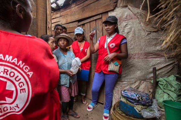 Red Cross volunteers talk to villagers about the plague outbreak. Photo / AP