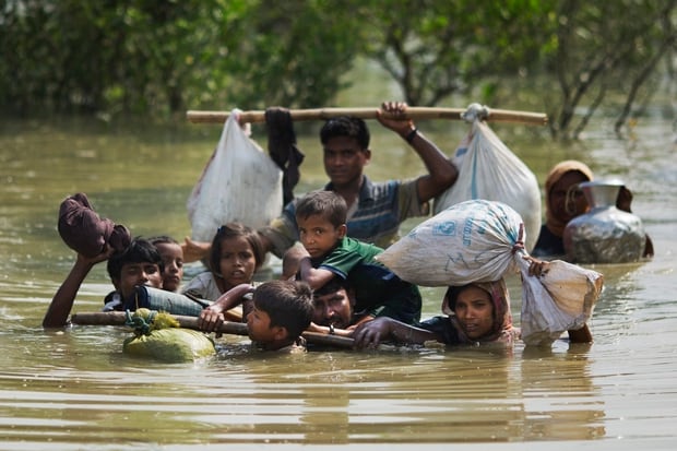 A Rohingya family reaches the Bangladesh border after crossing a creek of the Naf river on the border with Myanmmar, in Cox's Bazar's Teknaf area. Photo / AP