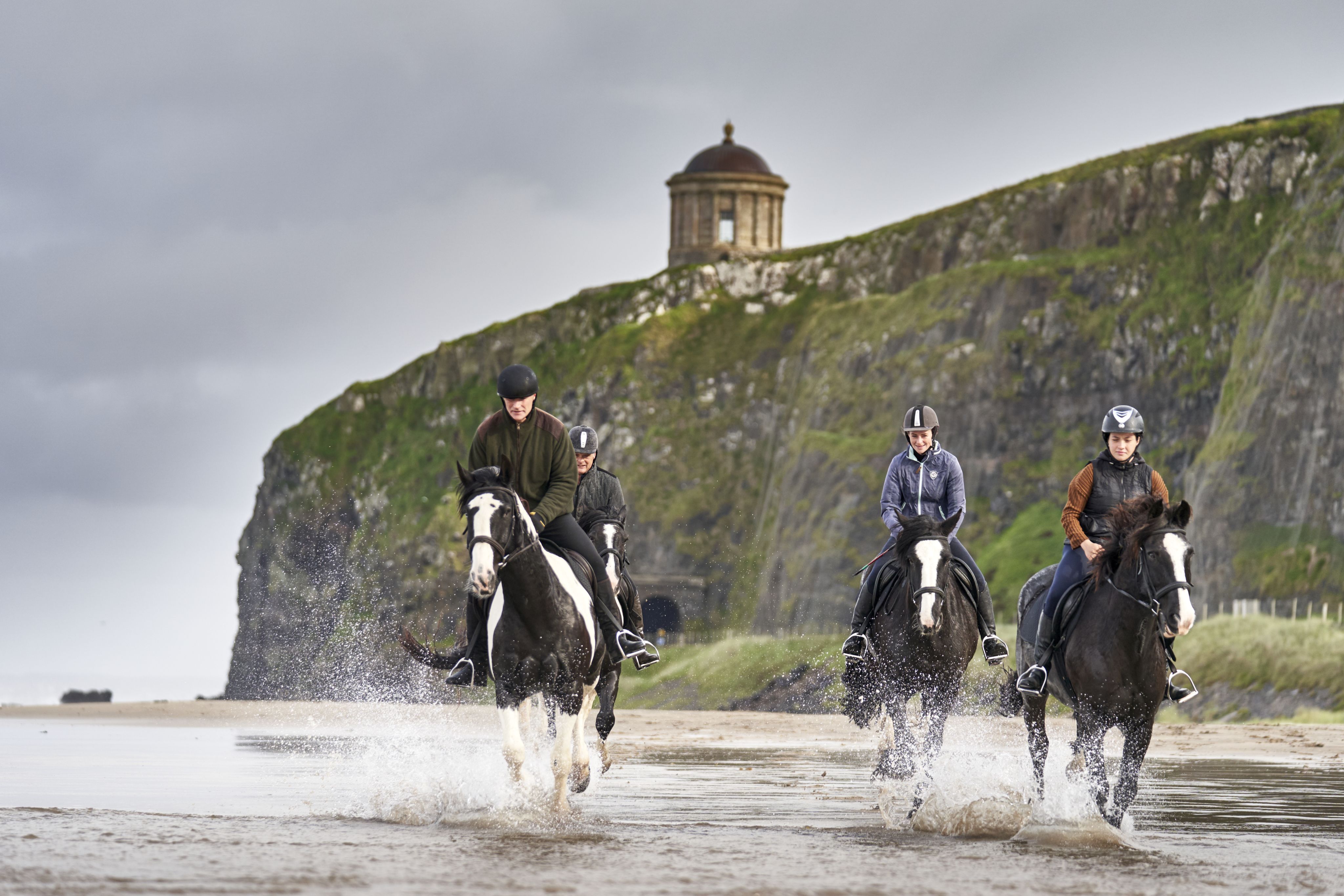 hands formed together with red heart paint