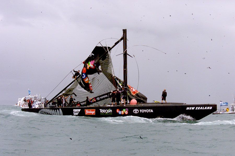 A crew member cuts of the sails after Team New Zealand's mast snapped during their fourth race against Alinghi. New Zealand Herald Photograph by Glenn Jeffrey