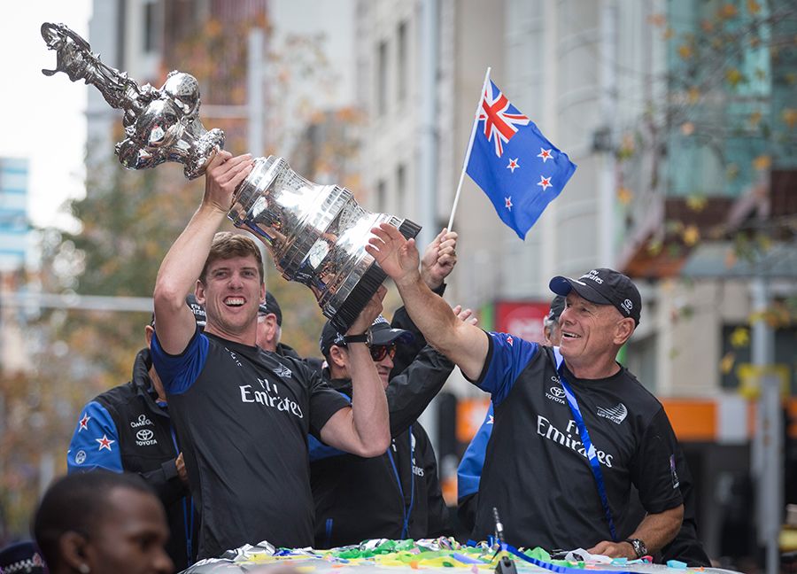 Team New Zealand's Peter Burling holds the Auld Mug with Grant Dalton.