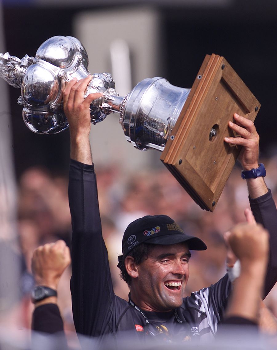 Team New Zealand skipper Russell Coutts holds the America's Cup aloft at the viaduct basin where New Zealanders celebrated retaining the cup in 2000. New Zealand Herald Photograph by Kenny Rodger.