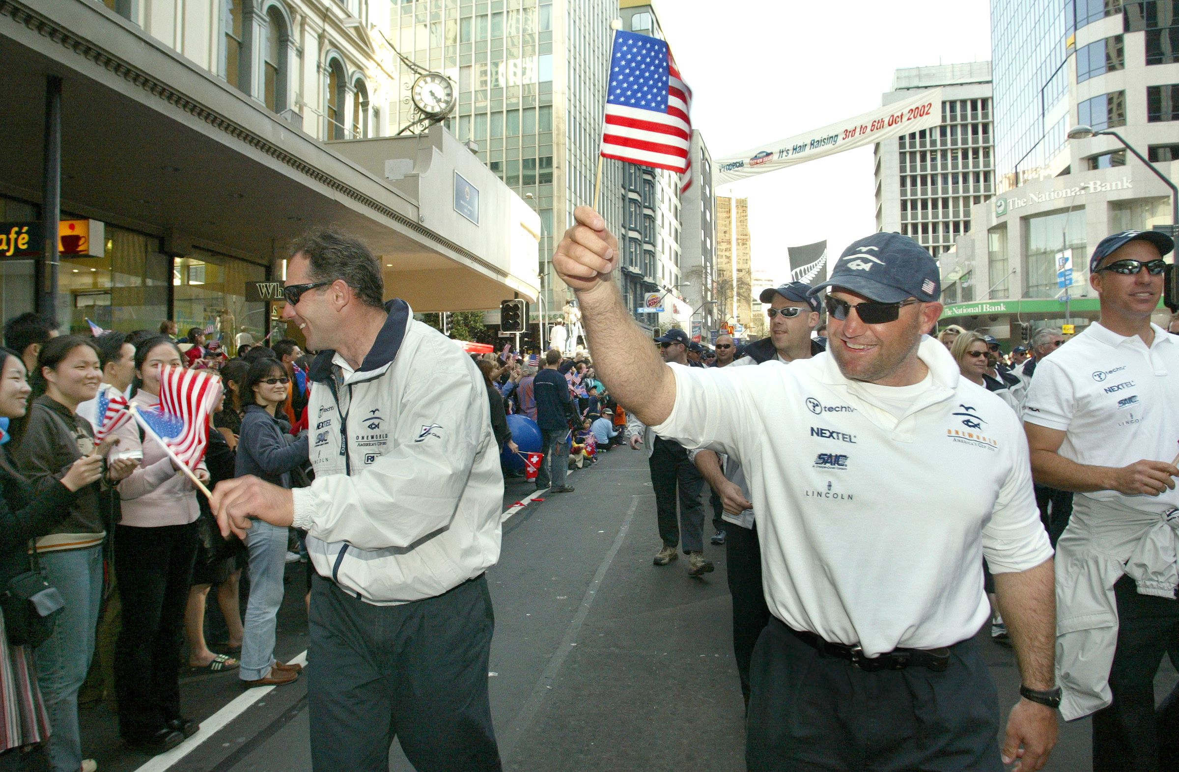 Ex-Team New Zealand members ( L - R ) Andrew Taylor and Craig Monk march with their team OneWorld from the USA during the official America's Cup 2003 & Louis Vuitton Welcome Parade down Queen Street, in Auckland City. 2002. Photo / Brett Phibbs, New Zealand Herald