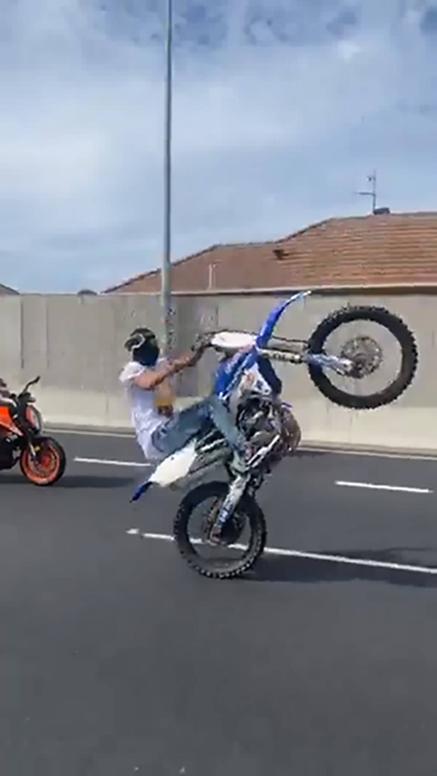 A dirt bike rider shows off a wheelie on a motorway in Auckland over the weekend. Image / Supplied 