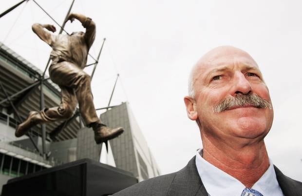Former Australia cricketer Dennis Lillee stands in front of a statue of himself at the MCG. Photo / Getty