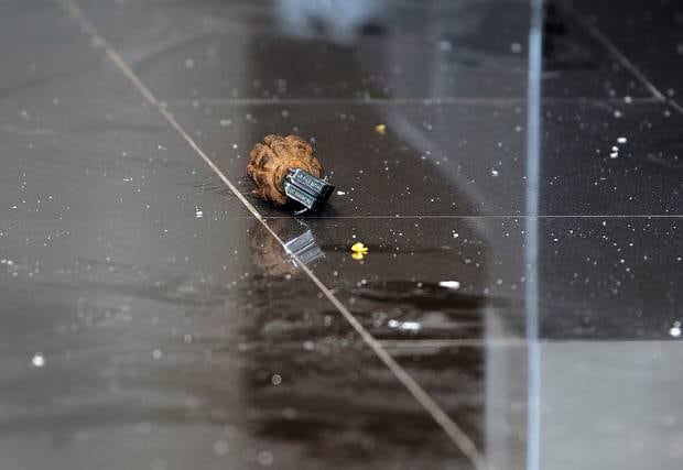 An unexploded grenade lies in a hallway in a hotel complex in Nairobi, Kenya after terrorists attacked an upscale hotel complex in the city's capital. Photo / AP