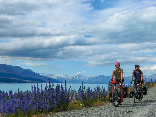 Tane Welton and Anneke Liefting at Lake Pukaki in the South Island. The couple say they've encountered the worst attitudes toward cyclists here in New Zealand. Photo / Supplied