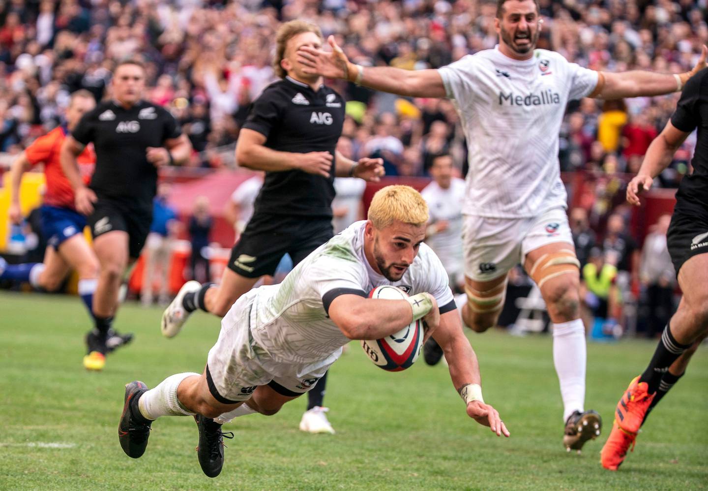 Nate Augspurger scores a try for the home side during an international rugby match between the USA Eagles and the All Blacks in Washington DC.  Athletic